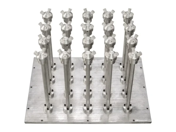 Thermoforming stacking mold with multiple metal stacking pins arranged on a grid plate.