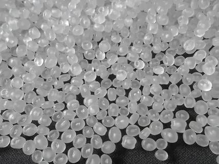 Clear PET resin pellets used as raw material for thermoforming processes.