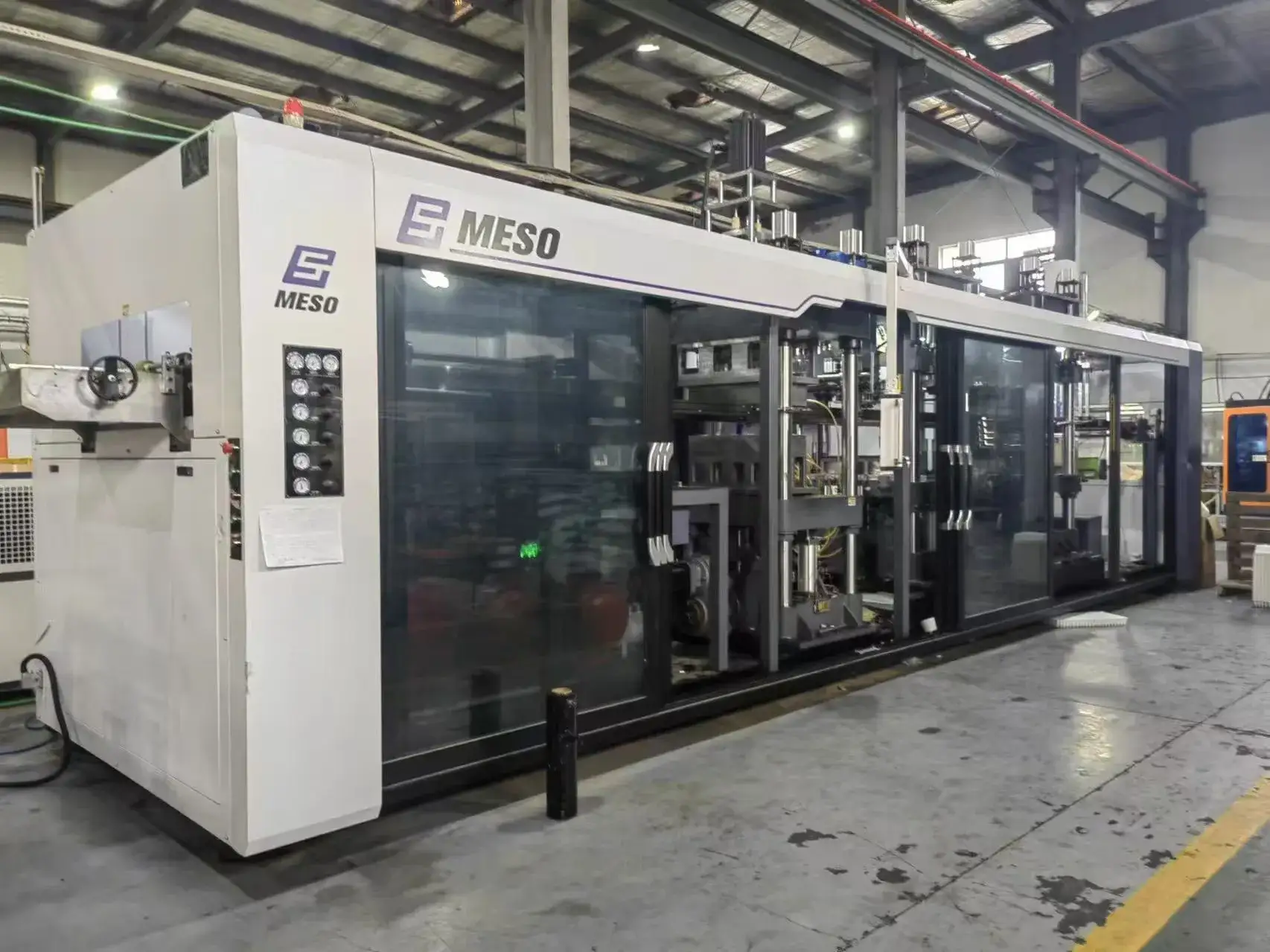Mesoforming industrial injection molding machine in factory setting