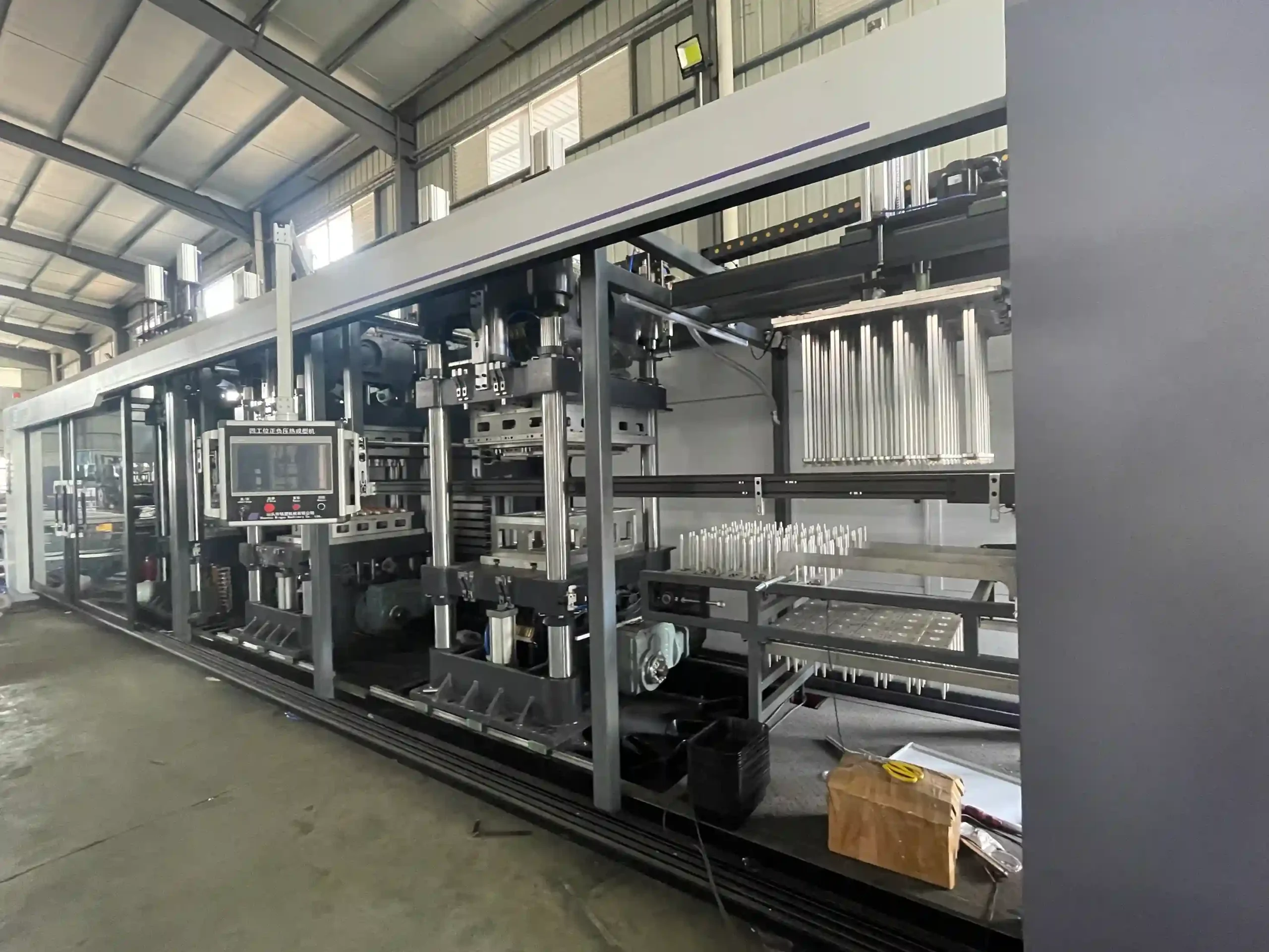Mesoforming Thermoforming Machine for industrial plastic forming, automated production line in factory.